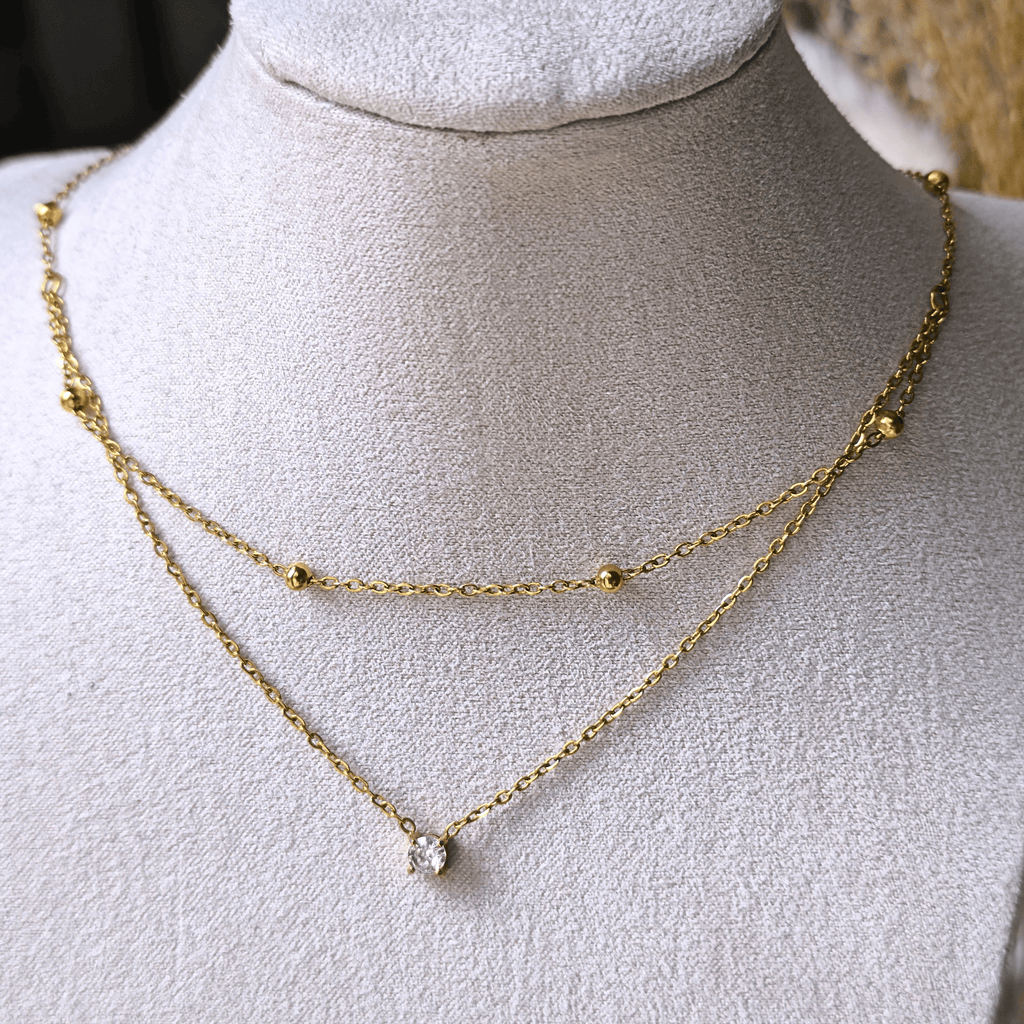 Collier double chaîne avec zircon central