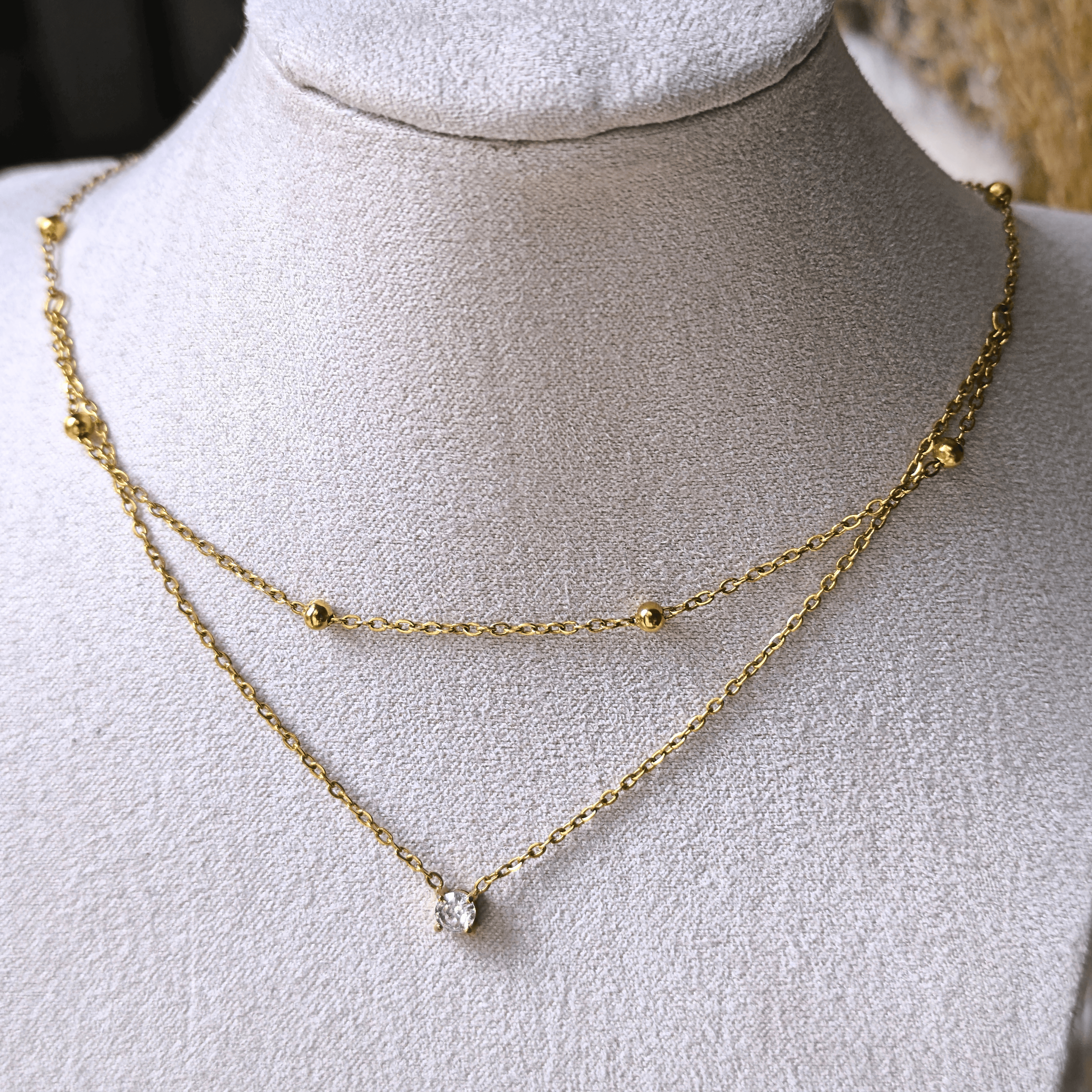 Collier double chaîne avec zircon central