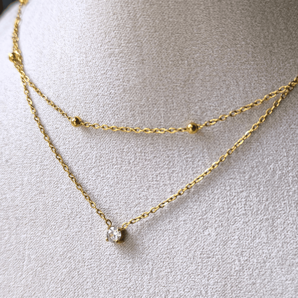 Collier double chaîne avec zircon central