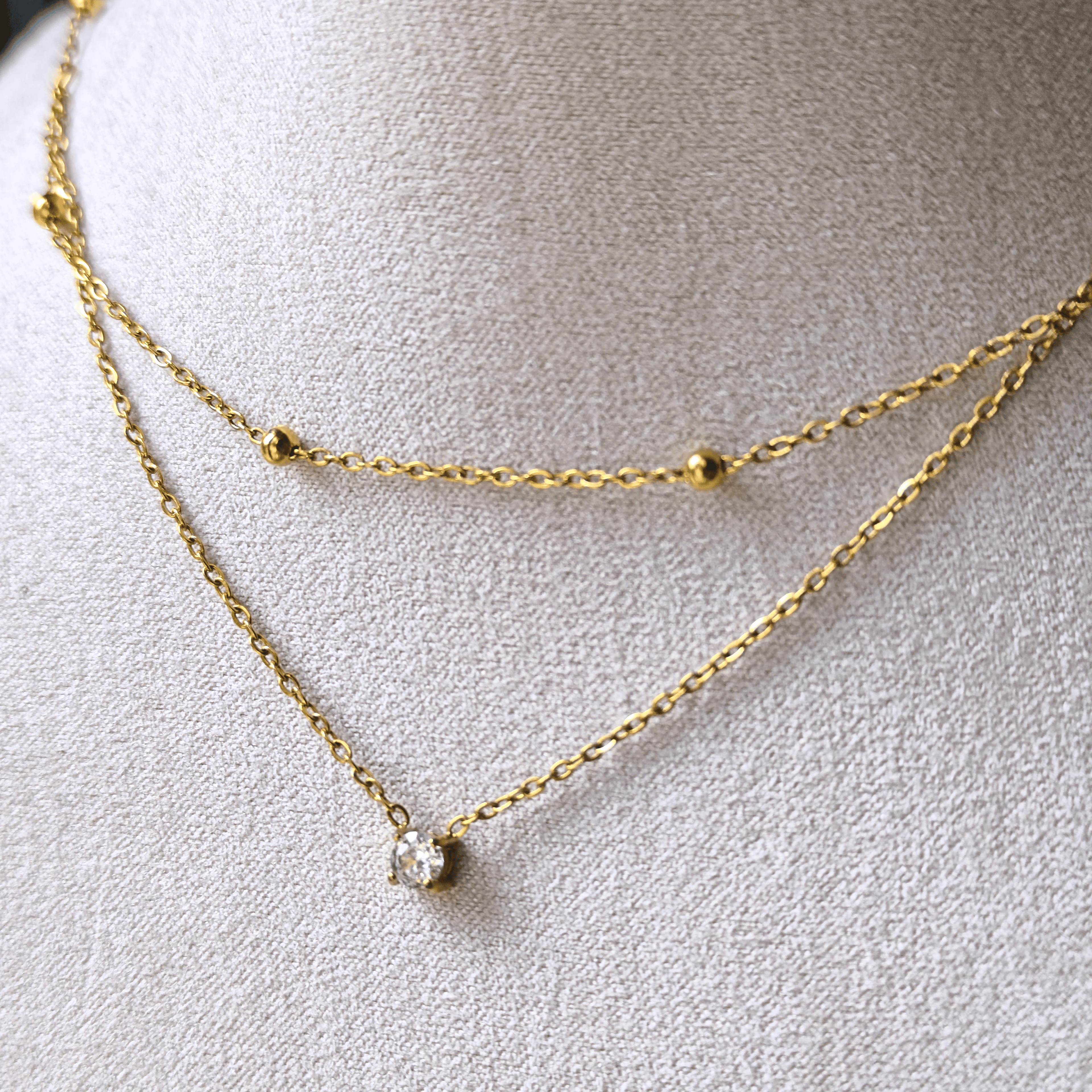 Collier double chaîne avec zircon central